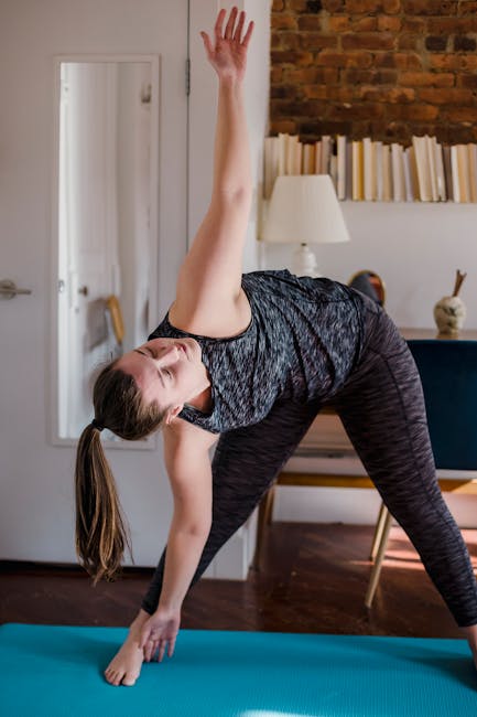 Woman smiling peacefully during a gentle morning yoga stretch in a cozy living room.